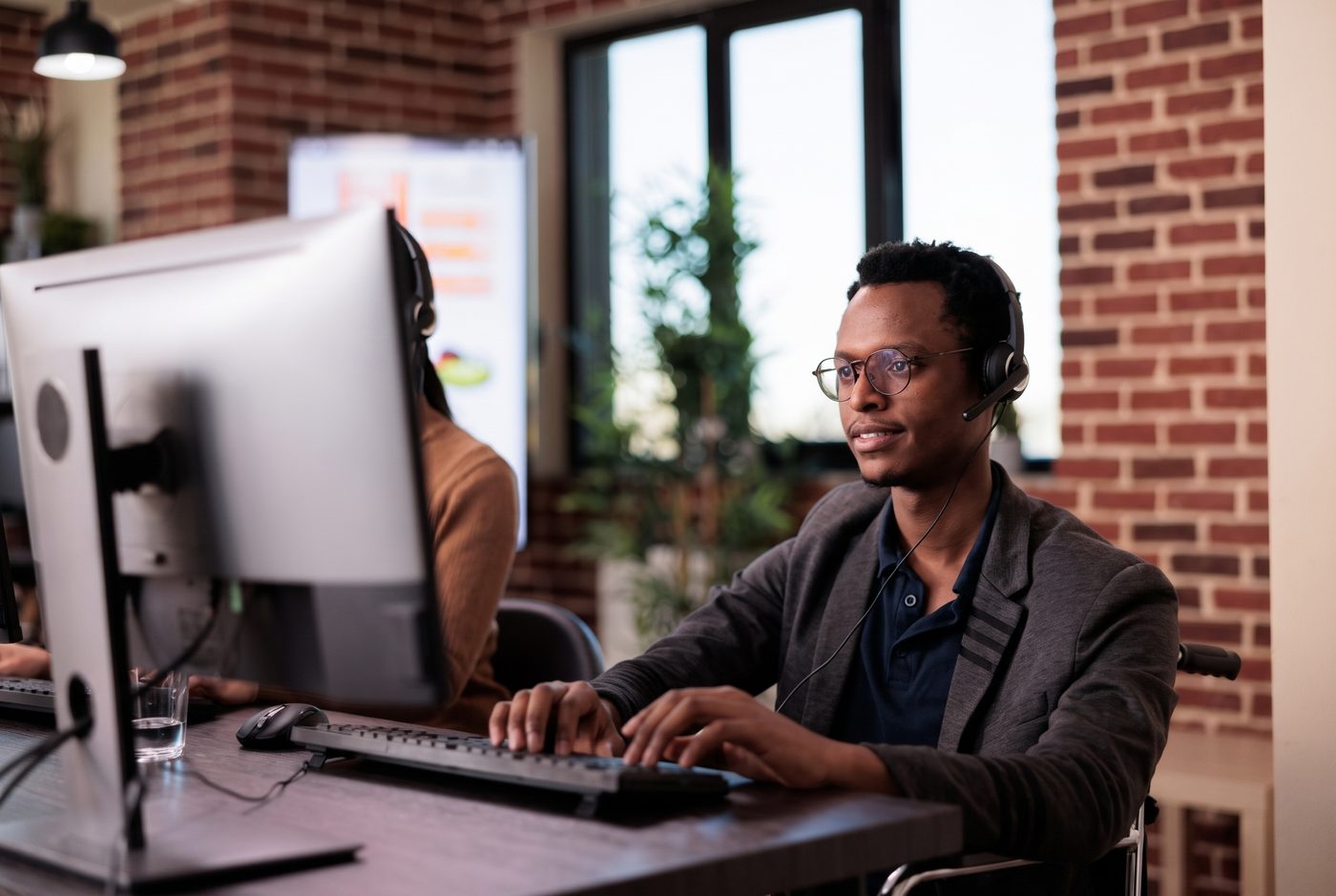Technical support specialist troubleshooting at a workstation